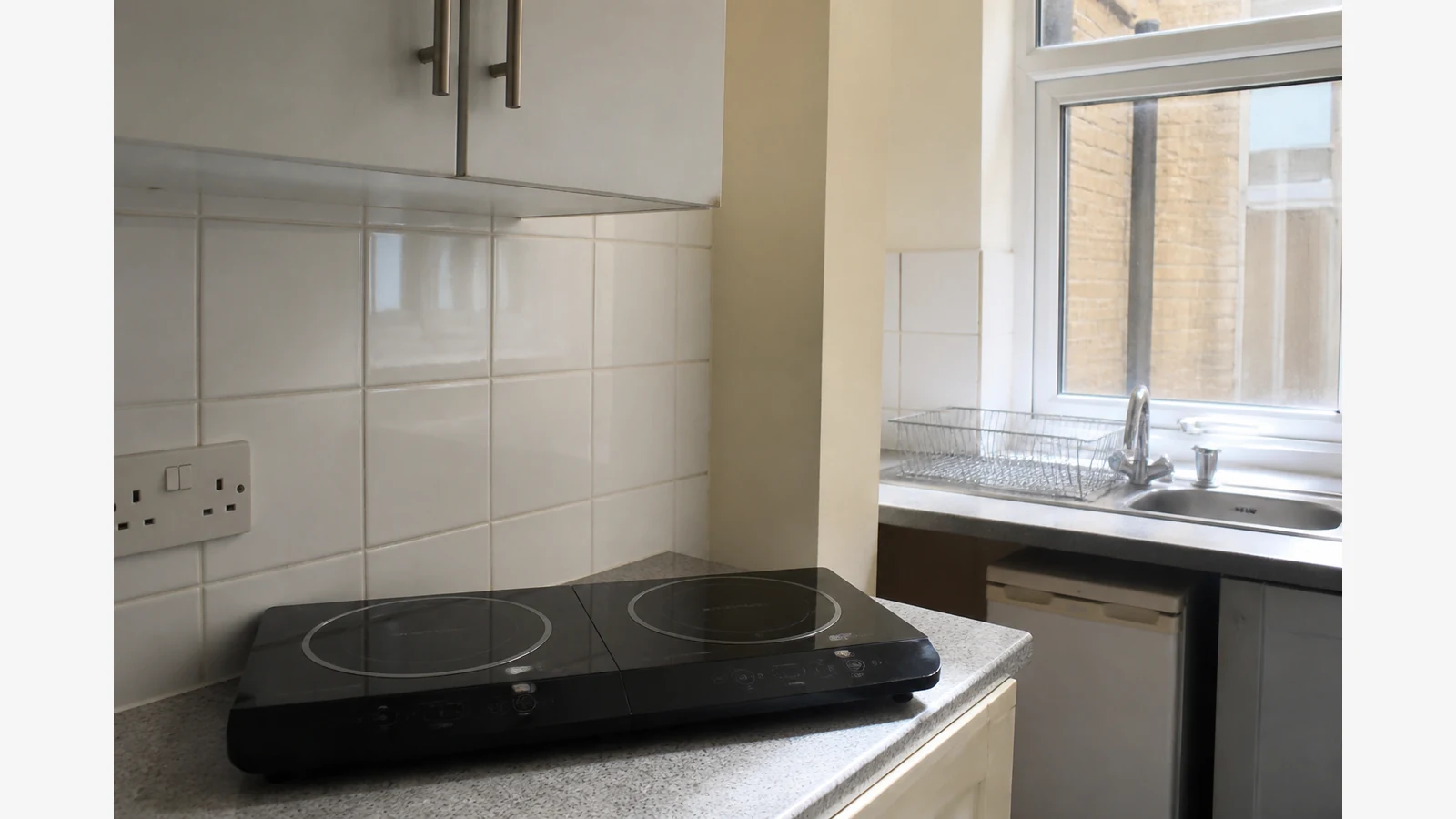 Portable double induction hob in a compact UK studio flat kitchen